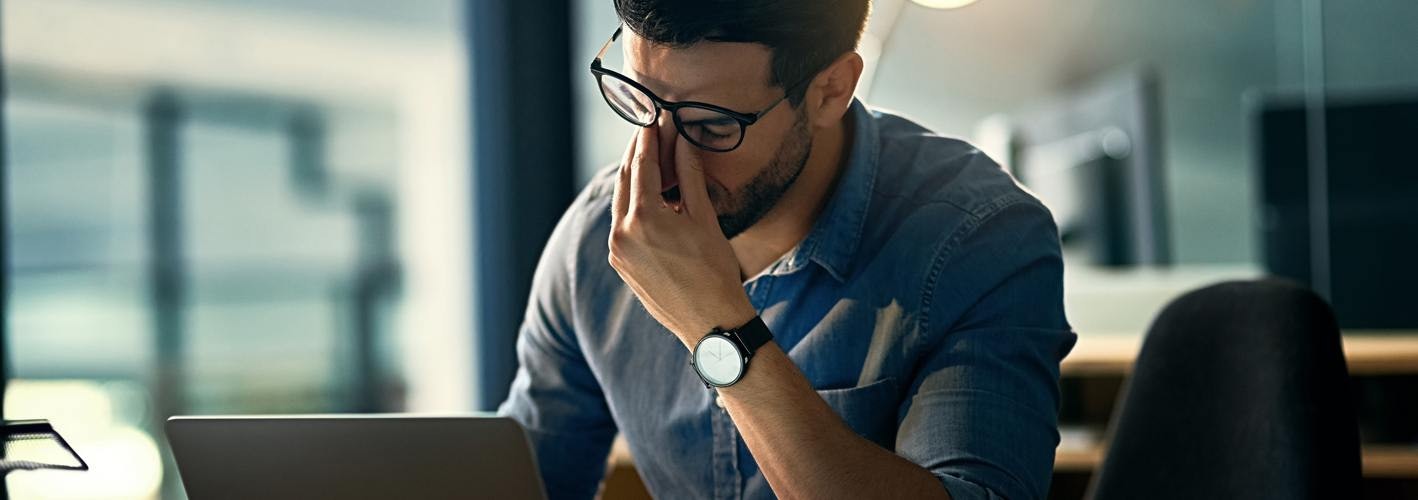 Marketer rubbing eyes in frustration